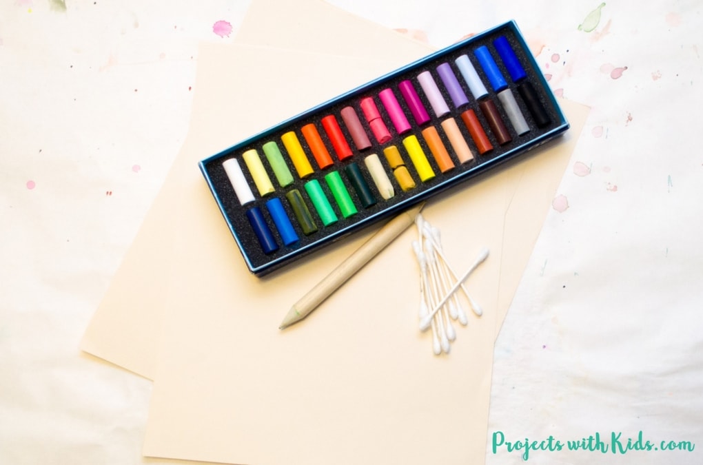 Create these stunning chalk pastel sunsets with kids. So much messy fun, kids will love learning and exploring with chalk pastels!