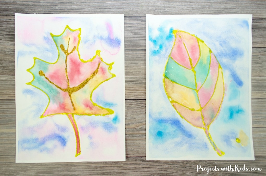 This fall leaf painting with glitter is a beautiful and colorful way to bring autumn colors indoors. Kids will love exploring the magical qualities of watercolor painting and using a common craft supply to create the glitter outlines! Includes 3 free leaf printable templates.