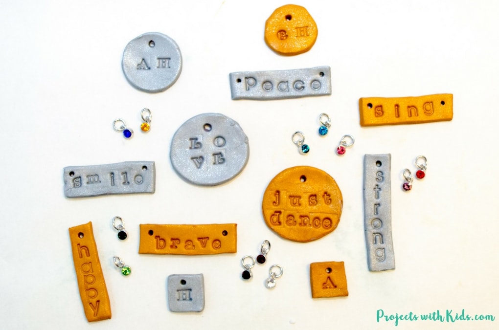 Learn how to make these stamped polymer clay necklaces that kids will have tons of fun making! These necklaces are sparkly and gorgeous and perfect for customizing, kids will love giving these as gifts and of course keeping some for themselves! Use initials, important dates, favorite hobbies, the possibilities are endless! 
