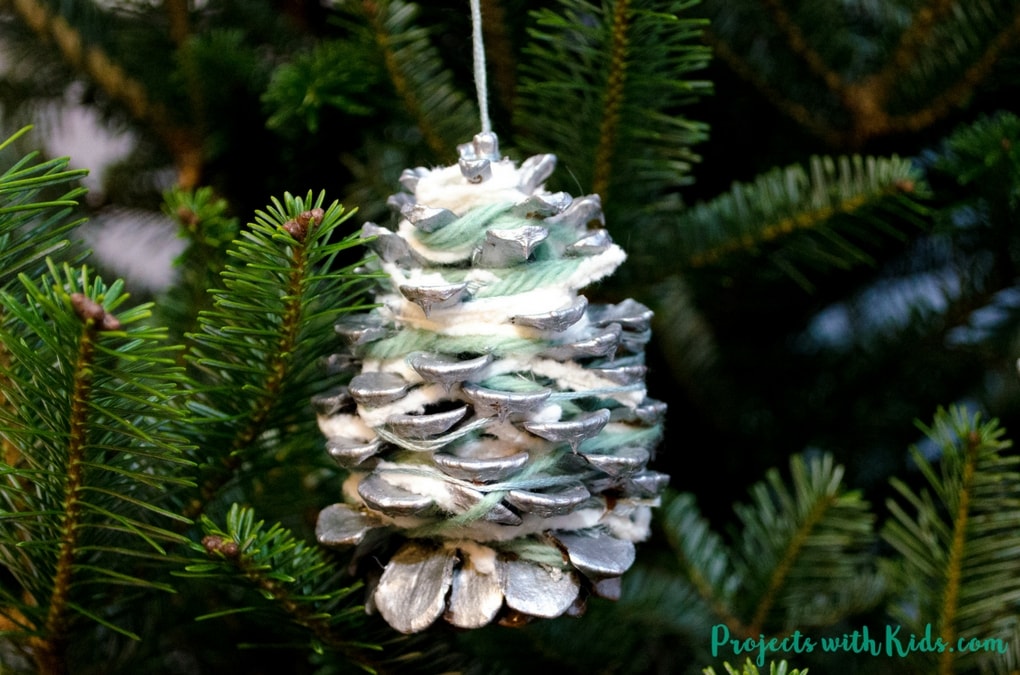 These pinecone ornaments are so simple and beautiful! They make a great fine motor activity and an easy Christmas craft kids of all ages will enjoy creating. 