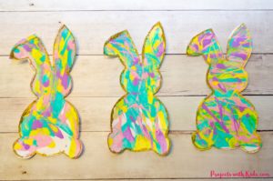 Scrape painting is a super fun process art activity that kids will love! Use beautiful spring colors to make these bunny silhouettes that are the perfect art project for spring or Easter. Edge them in gold glitter for an extra special touch! A great project for preschool aged kids and beyond. Free printable bunny template included.
