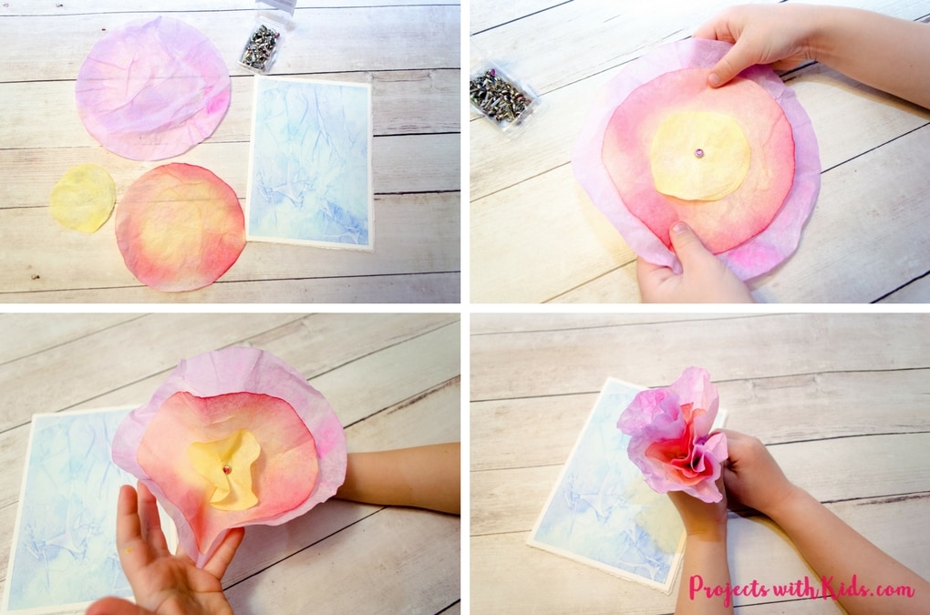 This 3D flower Mother's Day card craft is such a beautiful project for kids to make for their moms or grandmas for Mother's Day! Coffee filters and watercolor paint make a gorgeous 3D flower while the background is made with a unique and easy watercolor technique that kids will have fun creating. Kids will love making this gorgeous card for someone special.