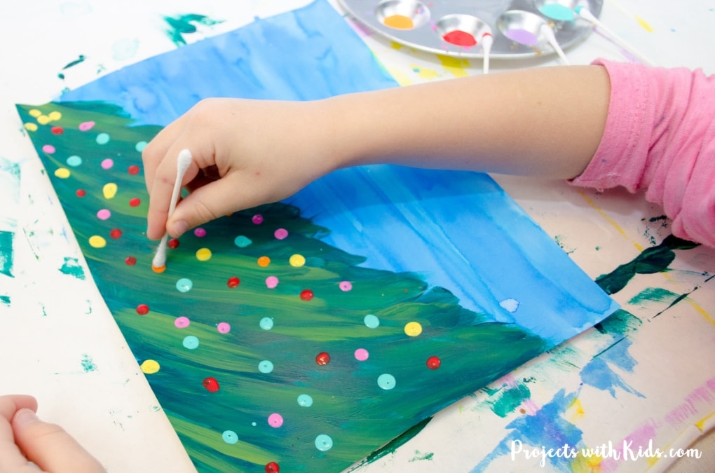 Kids will love creating this beautiful Christmas tree art project using a mixed media approach. Fun and easy techniques make this a wonderful Christmas craft activity! 