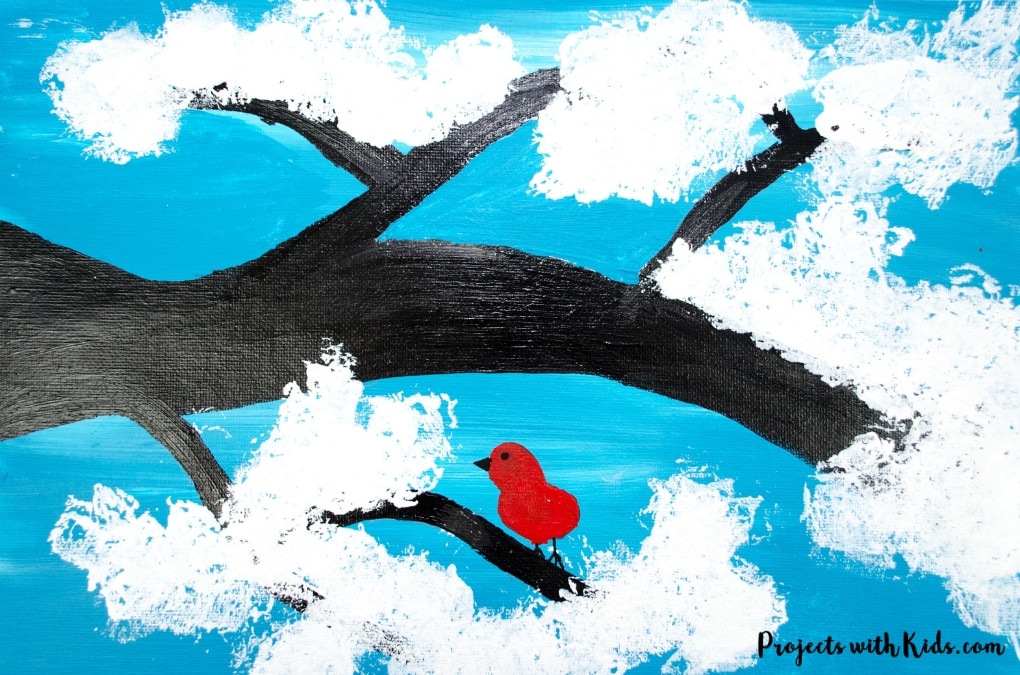 Kids will love creating this cute & easy winter tree painting using cotton balls. Add in a fingerprint red bird for an extra fun winter touch. Free printable branch template included.