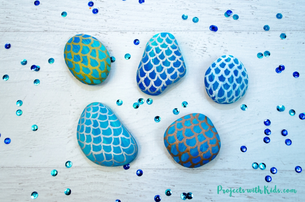 Easy steps for how to draw mermaid scales on painted rocks. A fun rock painting activity for kids that would be perfect for playdates, birthday parties, summer camps or any time!