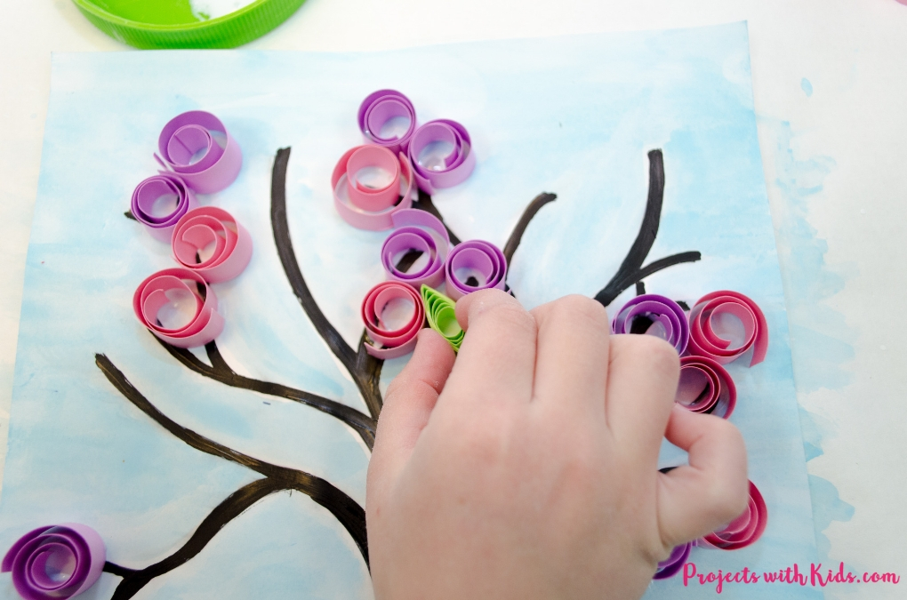 Make this gorgeous blossom spring tree craft with kids! Use easy paper quilling techniques and a free printable tree template. 