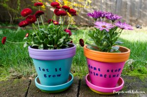 These bright and cheerful DIY painted flower pots are so fun and easy for kids to make! A wonderful kid-made gift idea for Mother's Day, and a great summer craft project.