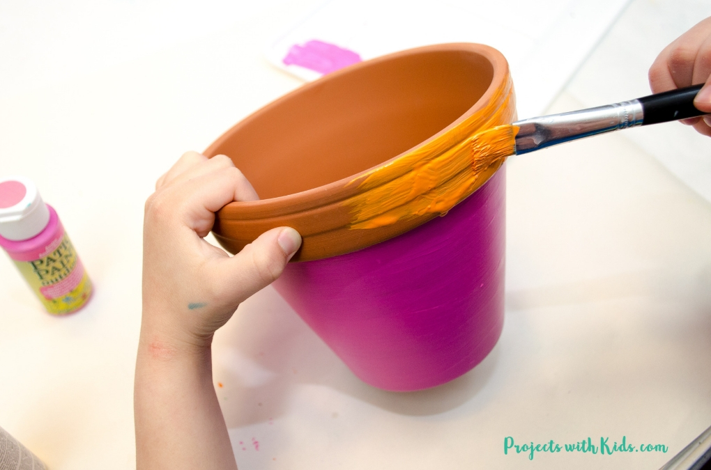 These bright and cheerful DIY painted flower pots are so fun and easy for kids to make! A wonderful kid-made gift idea for Mother's Day, teacher appreciation gift, and a great summer craft project. 