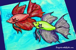 2 watercolor fish on a blue watercolor background.