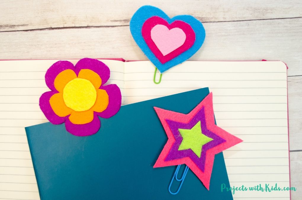 3 colorful felt bookmarks in a heart shape, star and flower shape with 2 notebooks.
