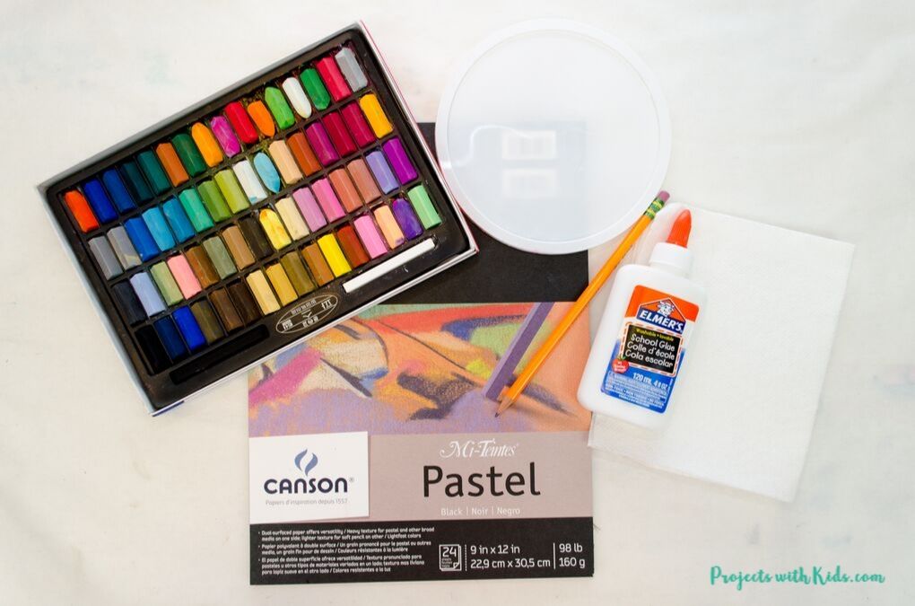 Chalk pastels, black pastel paper, plastic lid, pencil, white glue