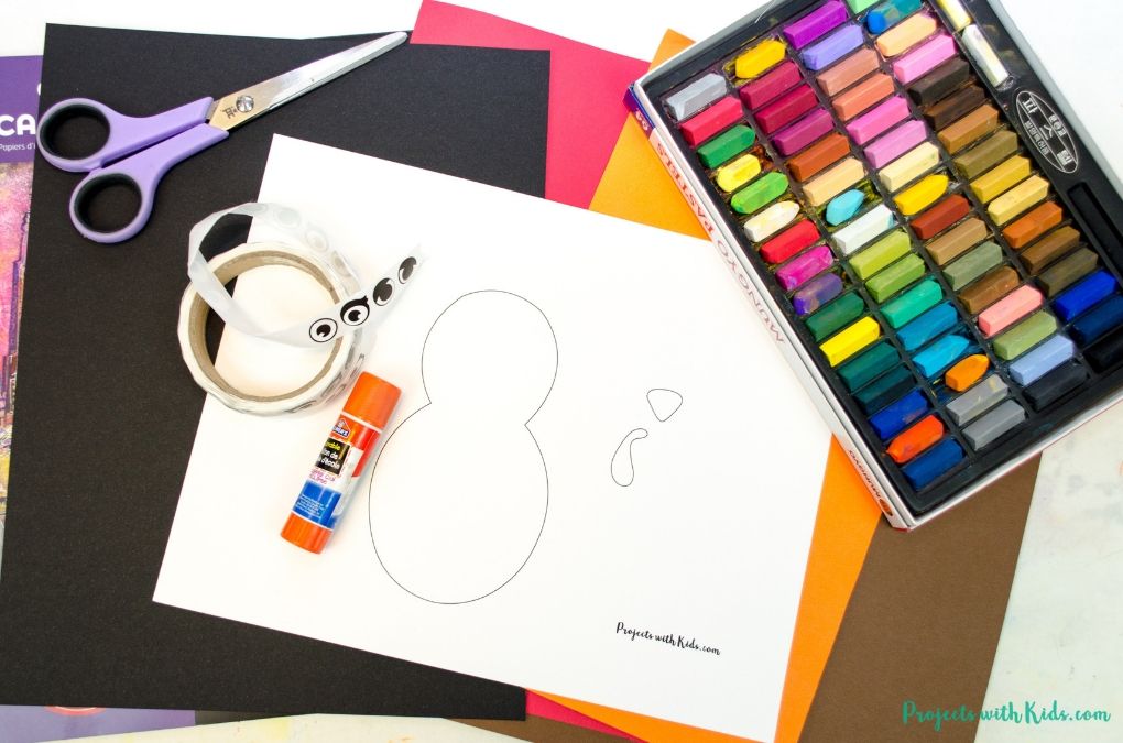 Supplies needed to make a chalk pastel turkey craft. Printable template, chalk pastels, scissors, glue stick, cardstock, black drawing paper, eye stickers.