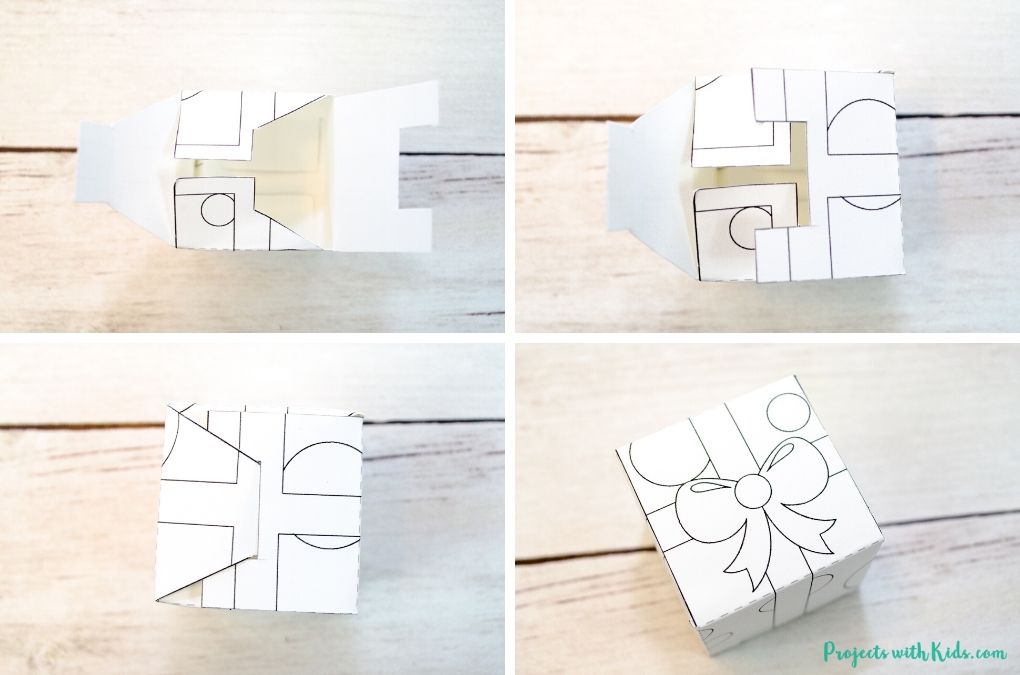 Finishing gluing and folding together a present box printable paper craft