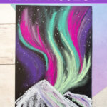Snowy mountains northern lights art project for kids to make.