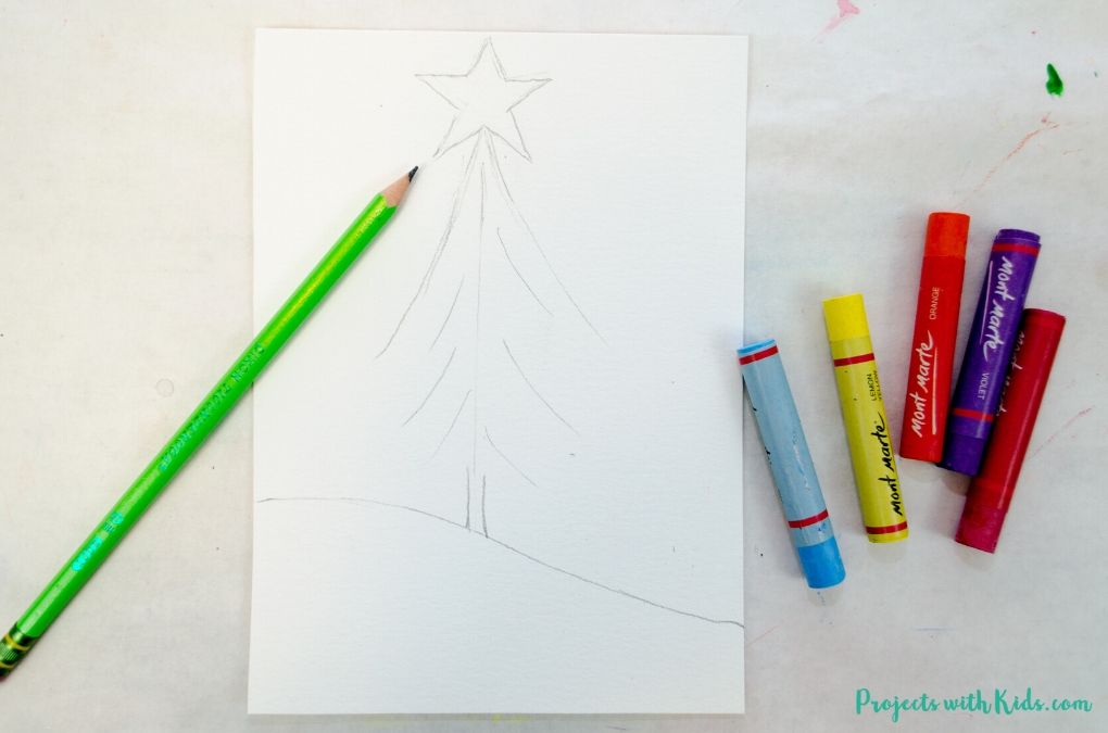 Drawing a Christmas tree on watercolor paper with pencil.