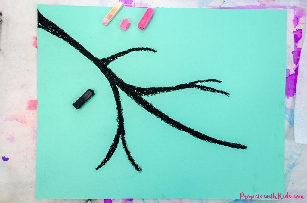 Drawing a tree branch with black chalk pastel