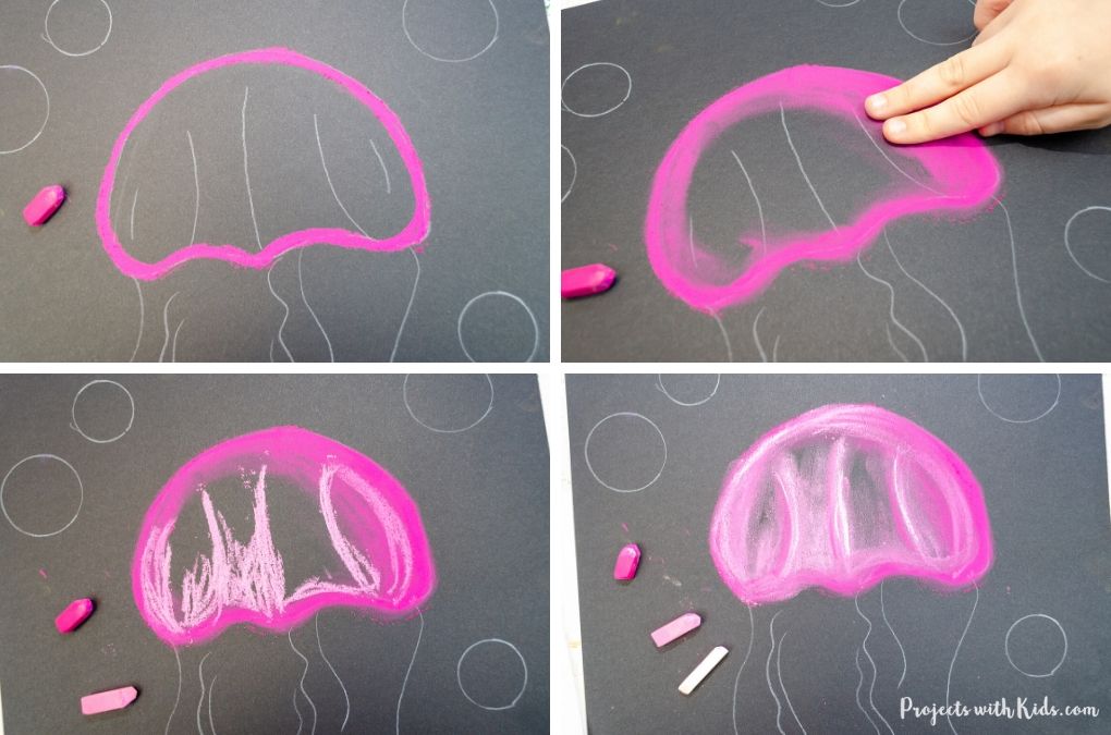 Drawing a jellyfish with chalk pastels and blending colors on black pastel paper.