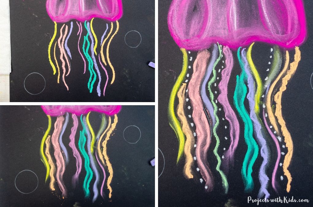 Making a colorful jellyfish art project with chalk pastel on black paper.