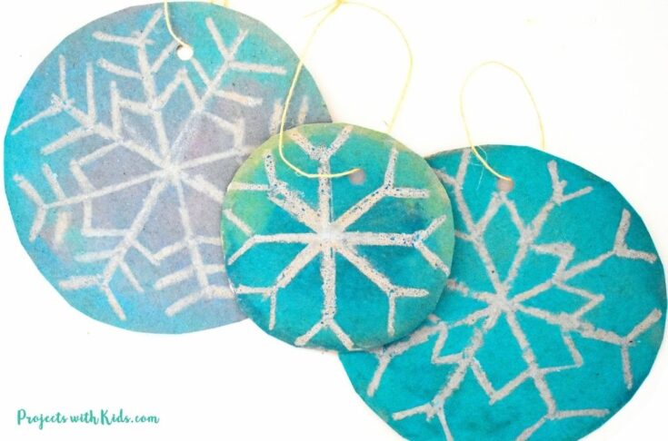 DIY snowflake ornaments using watercolors and oil pastels for kids to make