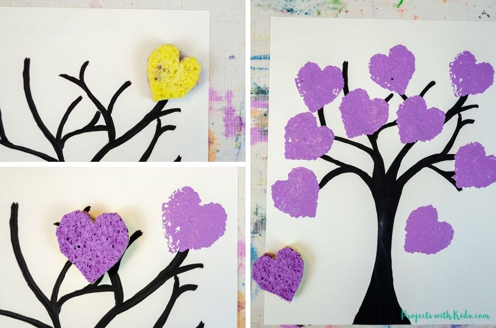 Using a heart shaped sponge to paint purple hearts.