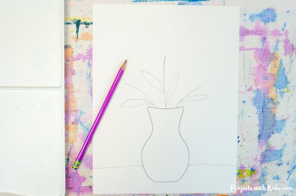 Drawing leaves and stems in a vase for a kids spring art project