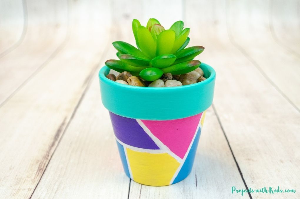 Geometric painted flower pots with fake succulent tween and kid craft idea