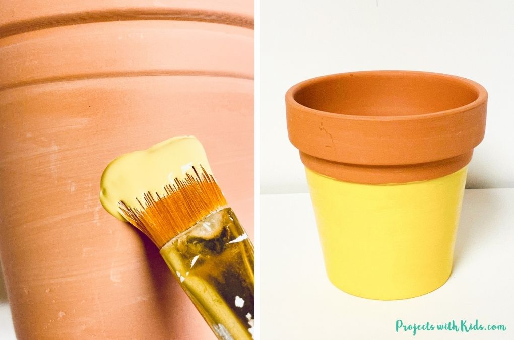 Painting a flower pot with yellow paint for a pencil painted flower pot craft