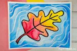 Watercolor fall leaf that looks like it's causing ripples in the water art project idea for kids