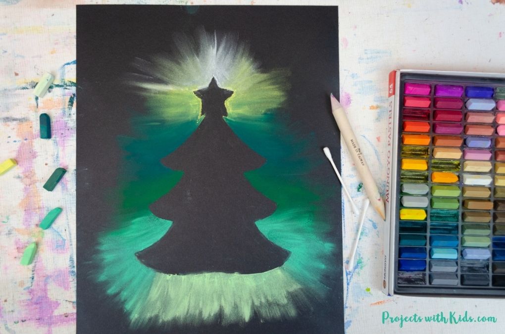 Christmas tree chalk pastel art with shades of green and yellow.