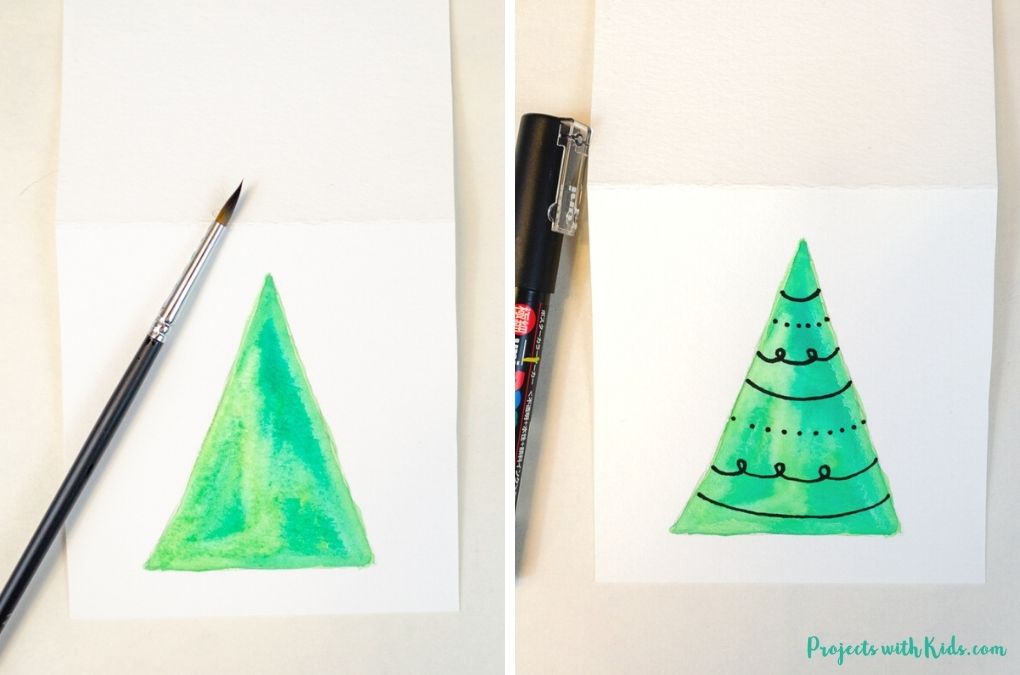 green watercolor triangle tree with designs using a paint pen