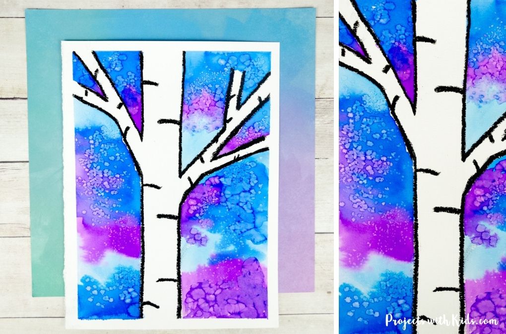 Watercolor winter birch tree painting idea for kids using a resist technique.
