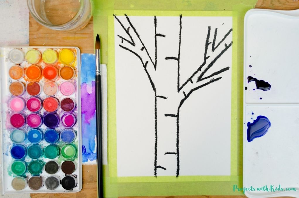 mixing blue and purple watercolor paint for a birch tree painting idea.