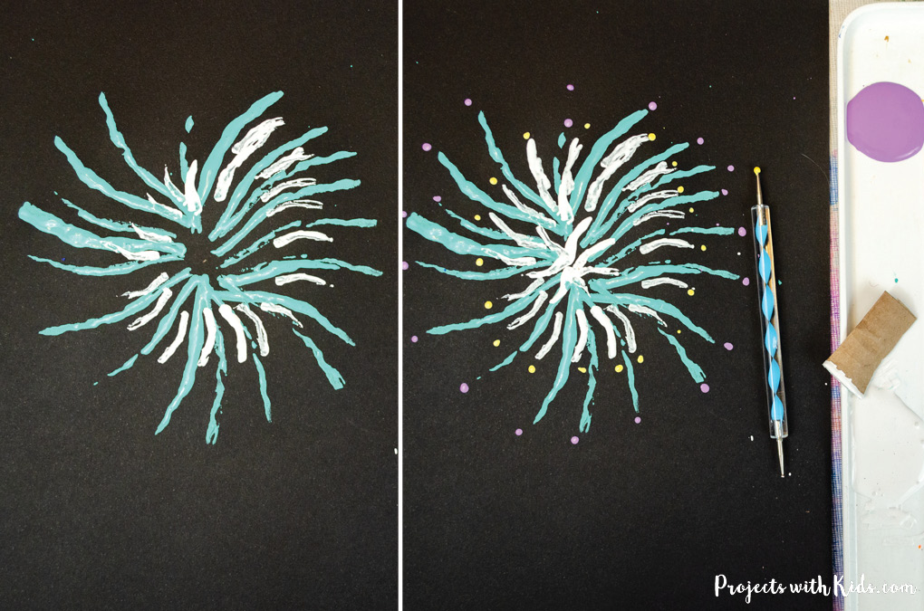 blue and white fireworks painting on black paper.