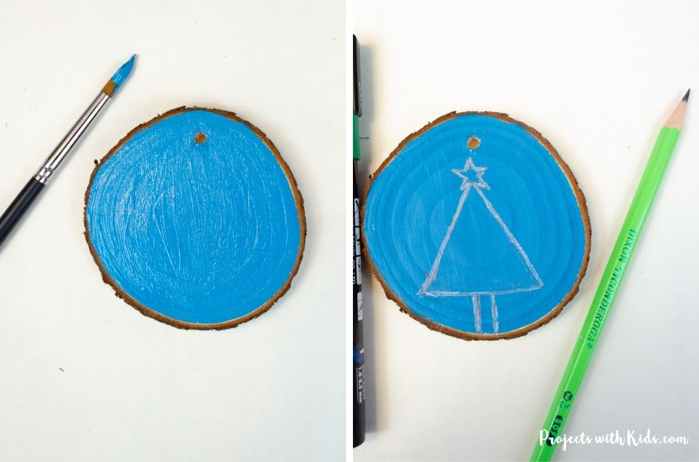 Drawing a tree on a painted wood slice ornament