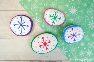 Colorful snowflake painted rocks winter project idea for kids