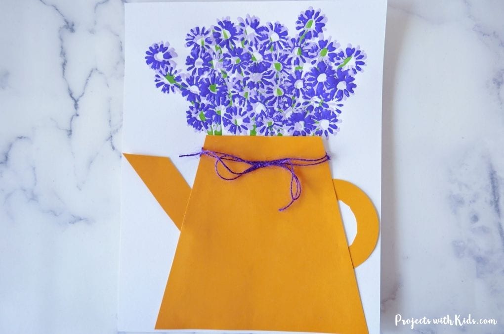 Mini painted purple flowers with a paper watering can art project
