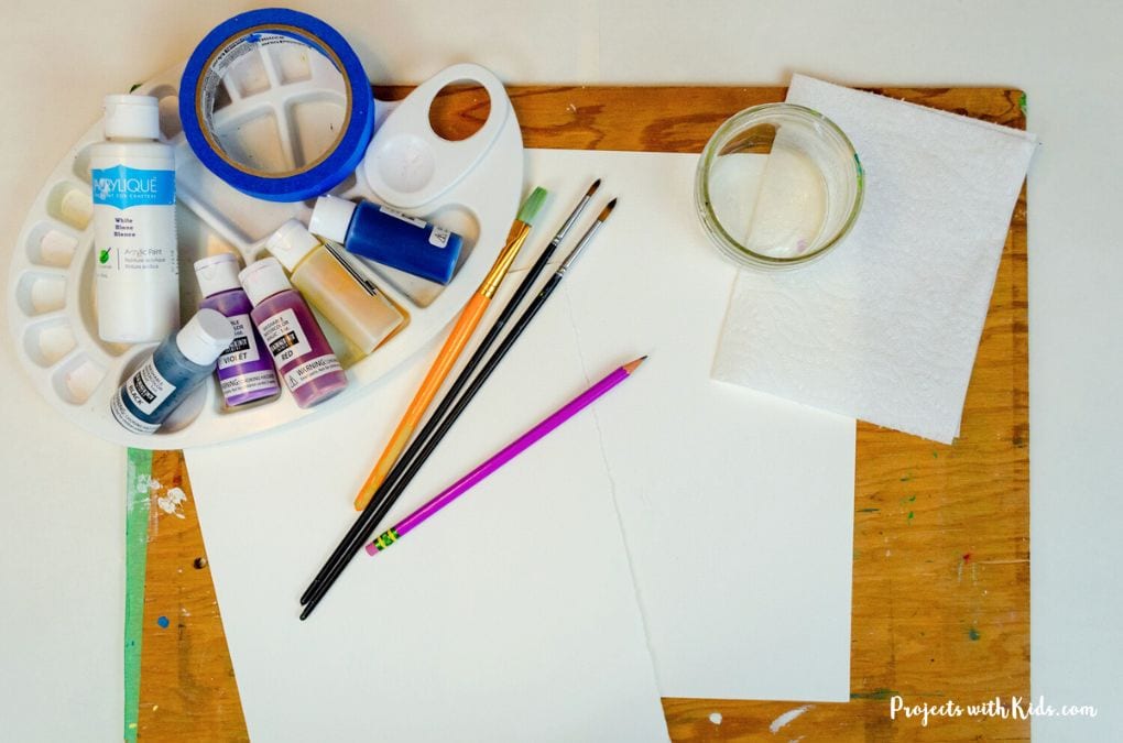 Watercolor supplies: paint, brushes, palette, paper.