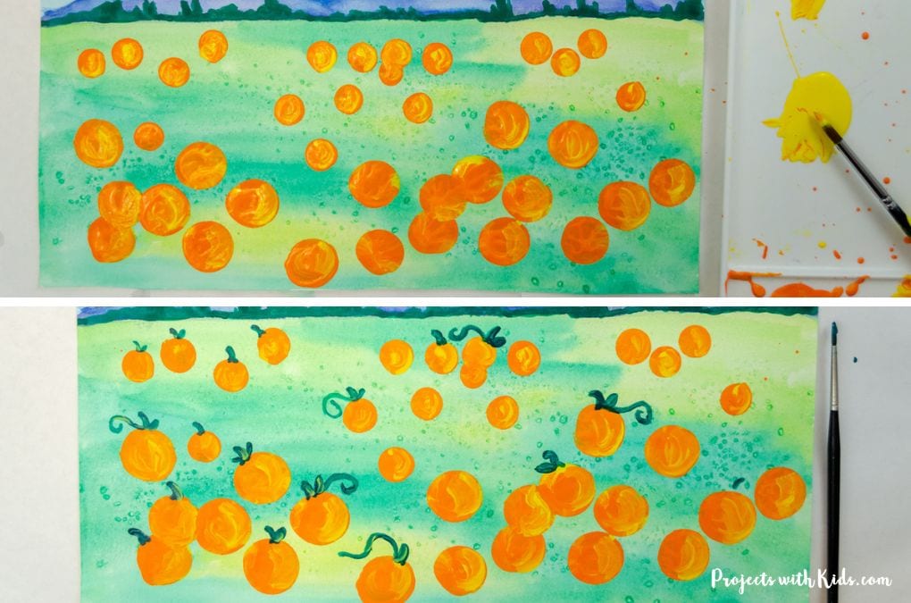 Adding details to a pumpkin patch art project for kids.