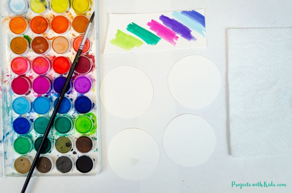 Watercolor paint set, watercolor paper cut into circles.