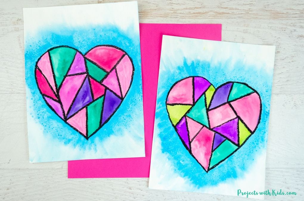 2 examples of a geometric heart painting using watercolors and oil pastels kids art project idea for Valentine's Day.