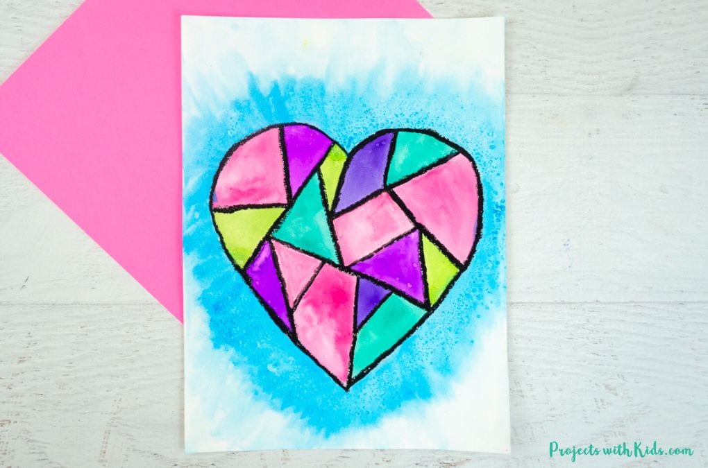 Colorful geometric heart art painting using black oil pastels and vibrant watercolor paint. For kids to make for Valentine's Day.