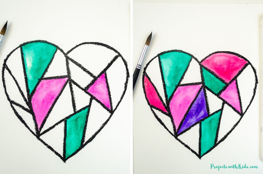 Painting sections of a geometric heart art project using colorful watercolors.