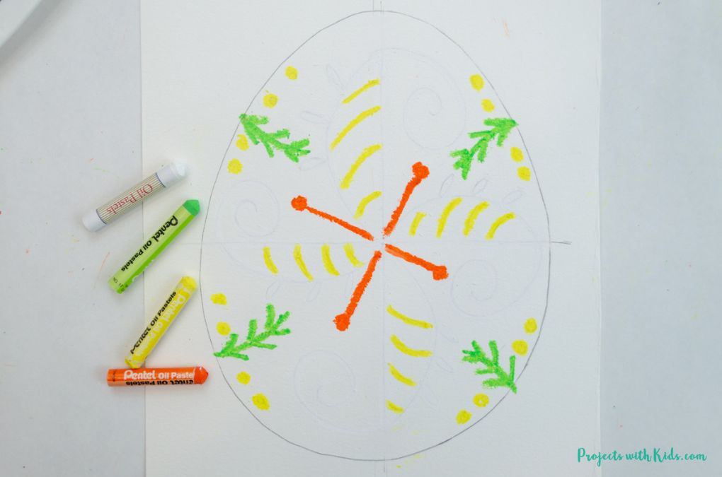 Drawing with oil pastels on an Easter egg template.